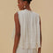 back view of model wearing white cotton tank with eyelet and lace detail