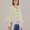 model wearing textured off white slight cropped cardigan with with blouson sleeves