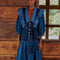 model wearing mixed denim midi dress with elongated collar, button front, ruffle shoulders and tie waist