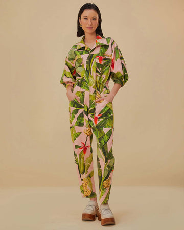model wearing pink jumpsuit with pockets, collar and all over banana leaves print