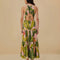back view of model wearing pink banana leaves maxi dress with ric rac tiers, cut-out top and open back