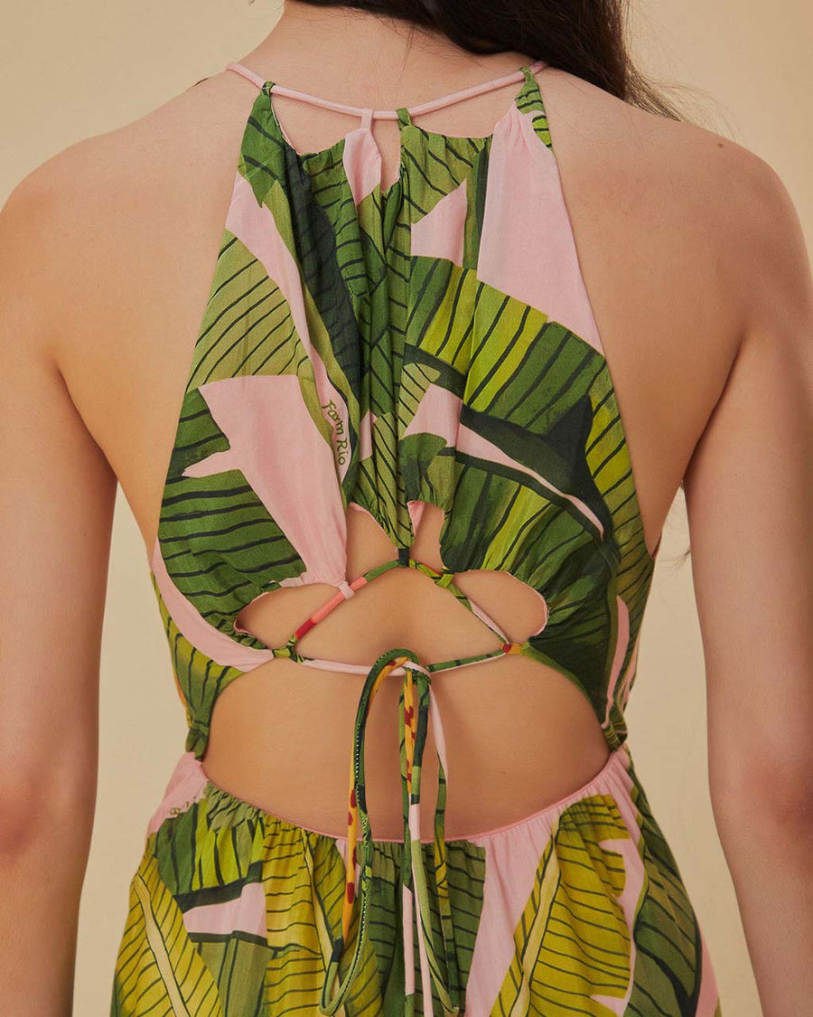 up close of model wearing pink banana leaves maxi dress with ric rac tiers, cut-out top and open back