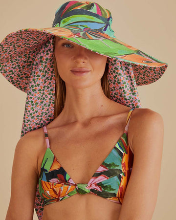 model wearing wide brim sun hat with colorful abstract print and pink floral print