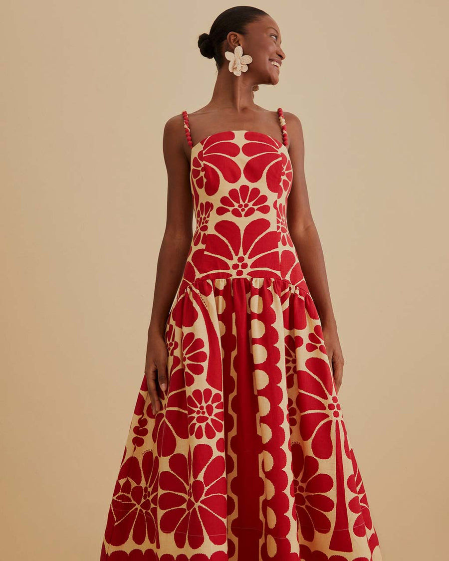model wearing red and cream abstract print dress with drop waist and bubble straps