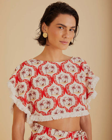 model wearing palm tree abstract print cropped top with white fringe detail