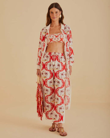 model wearing palm tree abstract print pants with tie waist