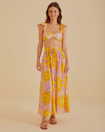 model wearing pink button front maxi dress with abstract sun print