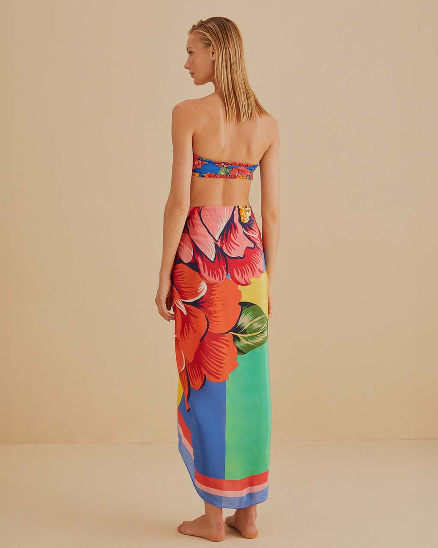back view of model wearing colorful bold floral swim cover up