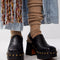model wearing black leather clogs with gold stud details at the sole