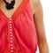 up close of model wearing bright red cotton tank with button front and lace applique detail down the front and hem
