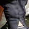 model wearing black short sleeve ribbed top with scalloped detail on the neckline and sleeves and has a button front