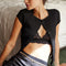 model wearing black short sleeve ribbed top with scalloped detail on the neckline and sleeves and has a button front