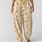 model wearing cream pinstripe balloon lounge pants with yellow dainty floral print