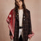 model wearing red triangle shawl with white folk floral print and white fringe