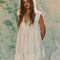 model wearing cream cotton mini dress with crochet scalloped deep v-neckline and cap sleeves