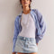 model wearing light denim skort with the shorts peeking out of the bottom