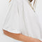 up close of model wearing white tee with raw edge detail and bat wing sleeves