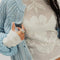 up close of model wearing ivory long sleeve top with floral lace front and back and lace trim on the hems of the sleeves