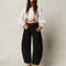 model wearing washed black barrel jeans