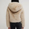 back view of model wearing ivory cropped faux fur jacket with hood