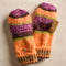 orange, pink, green and brown striped gloves/mittens folded up into mittens