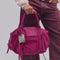 model holding raspberry pink leather baby emerson tote bag