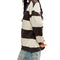 side view of model wearing black and white thick striped pullover crewneck sweatshirt