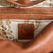 interior of dark brown leather tote bag with several pockets and zippers