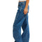 side view of model wearing low rise dark denim barrel jeans