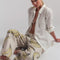 model wearing tan barrel jeans with all over painted banana print