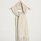 thick subtle blue and white oversized scarf with white fringe on a hook