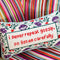 floral rectangular throw pillow with 'i never repeat gossip, so listen carefully' across the front on couch