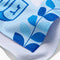 up close of blue and white Hanukkah tea towel