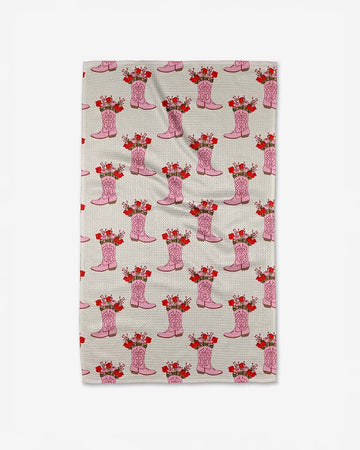cream tea towel with pink cowboy boot print with flowers inside them