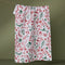white tea towel with red and green holiday doodle print
