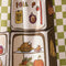 up close of green and white plaid tea towel with a fridge full of fall foods