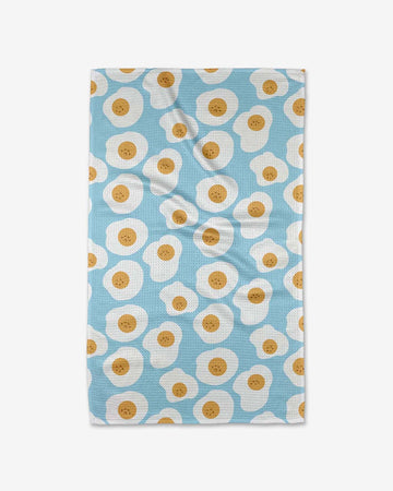 light blue tea towel with smiling sunny side up egg print