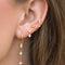 model wearing gold dangle earrings with crystal stud and drop