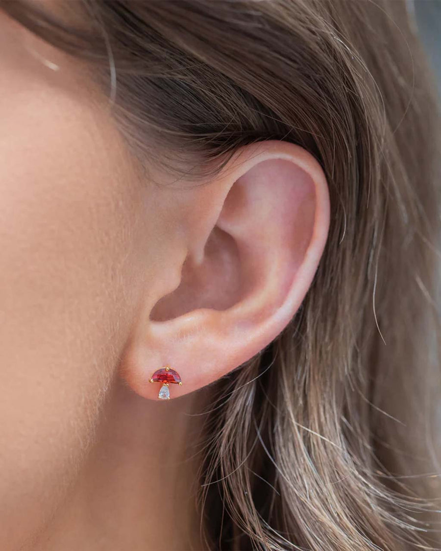 model wearing red mushroom stud earrings