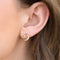model wearing gold crystal earrings with moon and dangle star charm