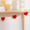 red heart felt garland on a table