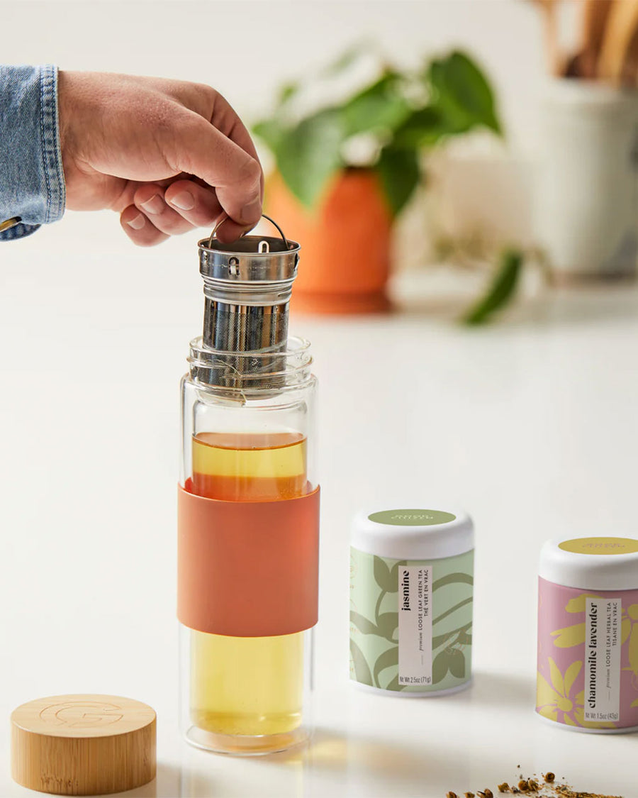 model using glass infuser tumbler with bamboo lid and terracotta removable sleeve
