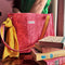 pink quilted floral tote bag with yellow printed interior