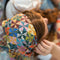 model wearing colorful patchwork square bandana on their head