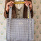 model holding blue and white gingham tote bag with yellow printed interior