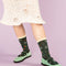 model wearing green socks with delicate floral print and cream trim