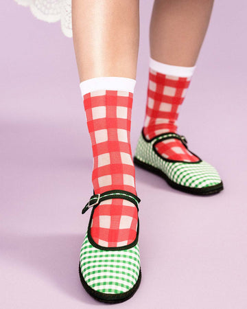 model wearing sheer crew socks with red and white plaid pattern