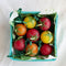 up close of set of 8 red, yellow and orange cherry tomatoes birthday candles