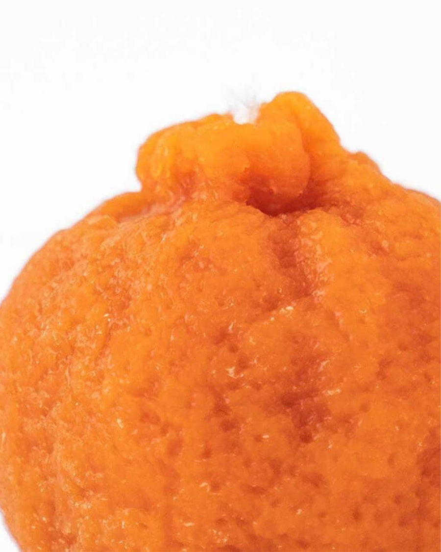 up close of mandarin orange shaped candle