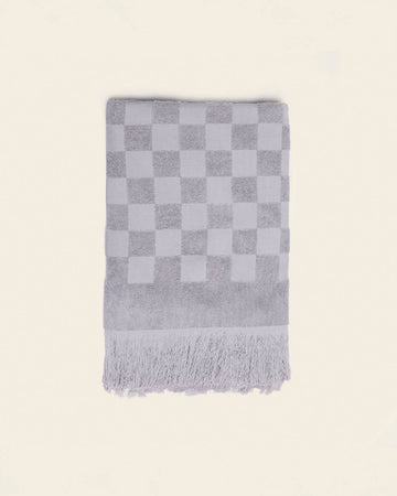 folded grey checkered bath towel